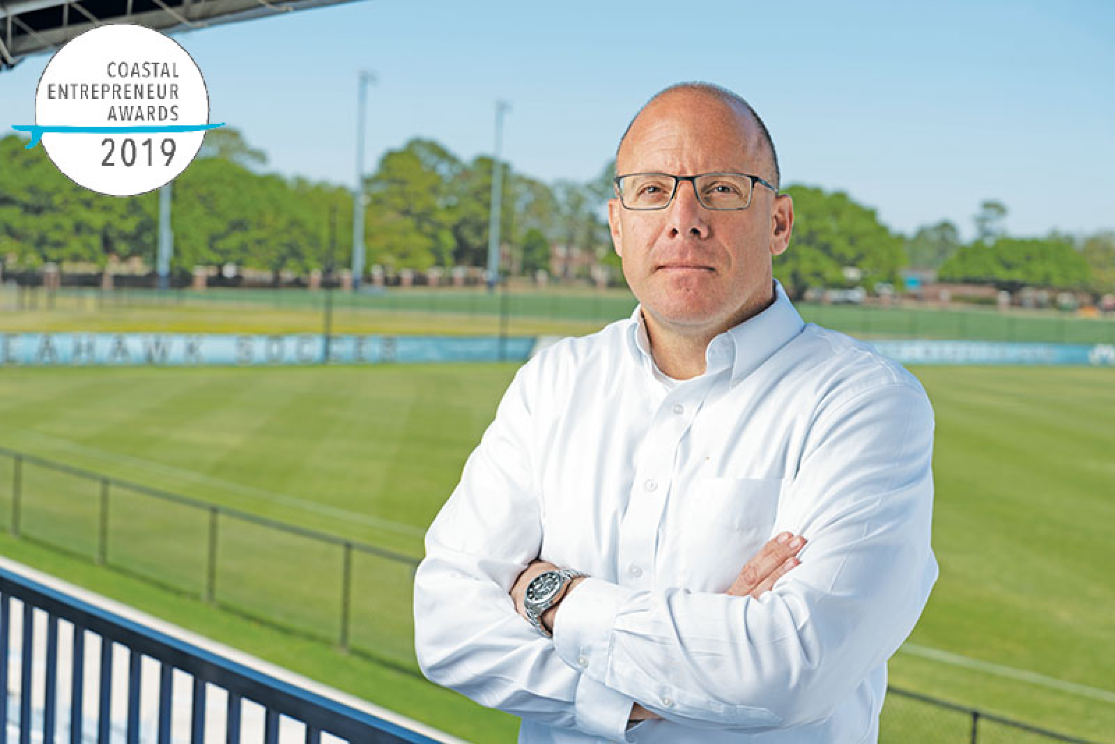 CEO of SportGait standing with arms cross with soccer field in the background